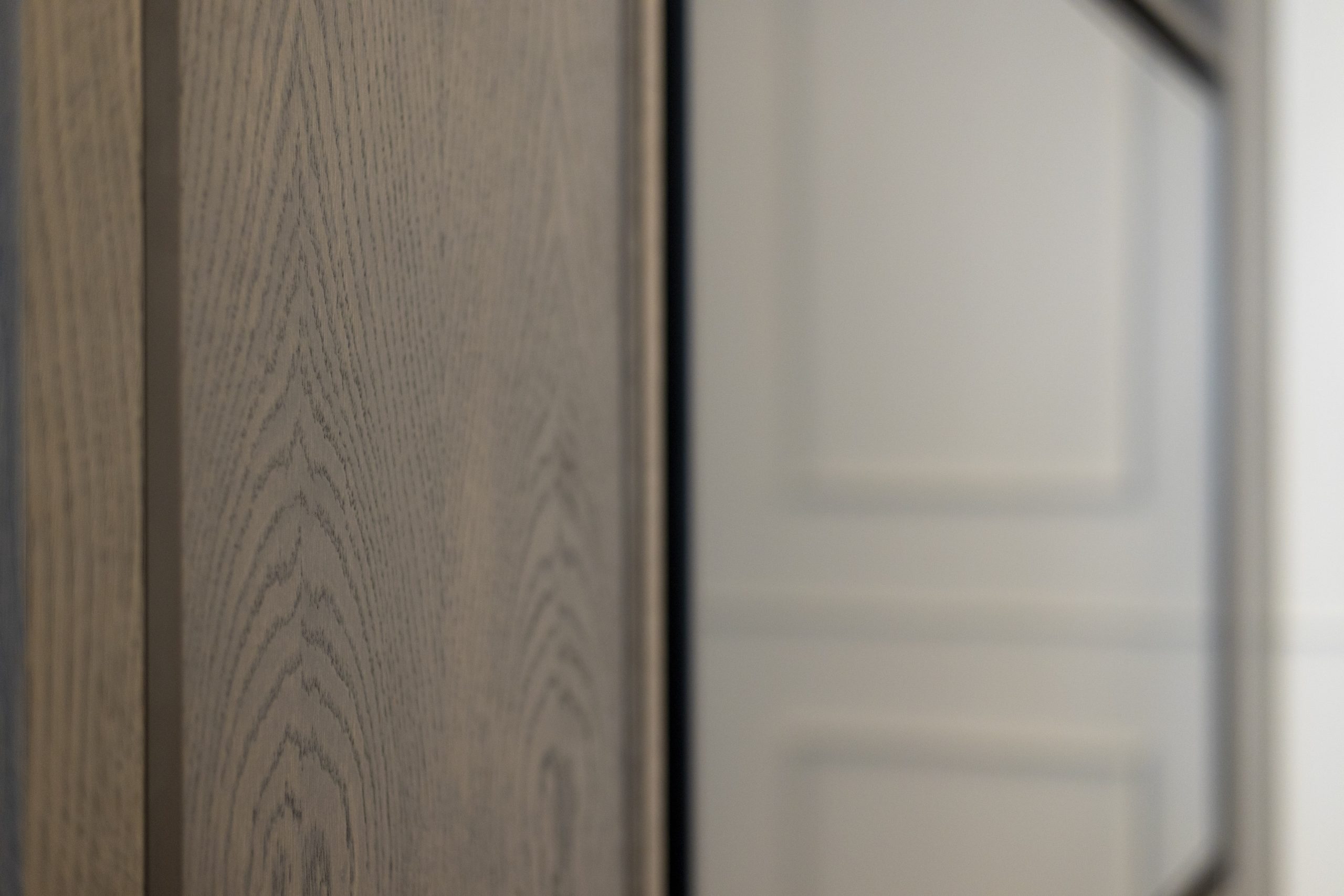 Close-up of a wooden panel showing detailed wood grain and texture.